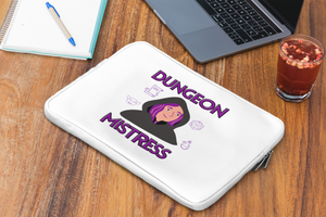 A white laptop sleeve with the image of a woman wearing a hooded cloak, surrounded by a d20, a potion bottle, a scroll, and a cartoonish goblin face. The words "Dungeon Mistress" are above and below the woman.